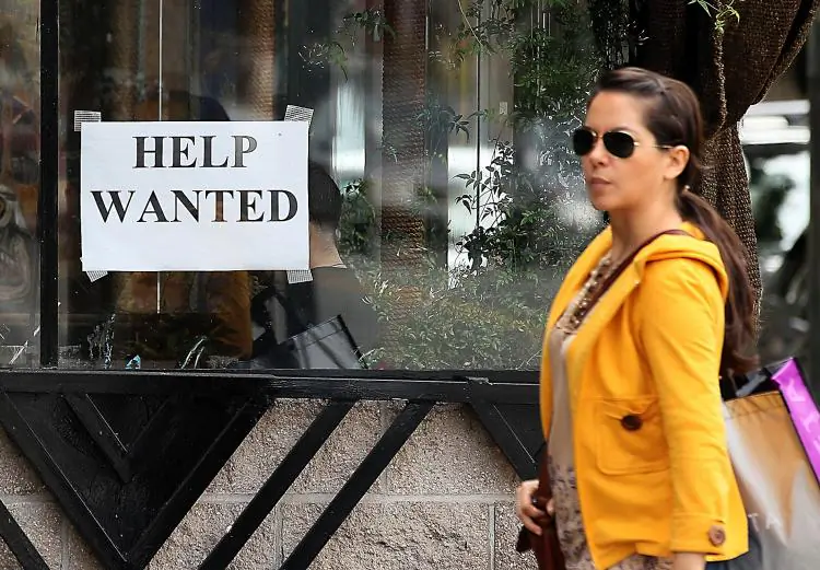A pedestrian walks by a help wanted sign in San Francisco, California, on March 25, 2011. (Justin Sullivan/Getty Images)