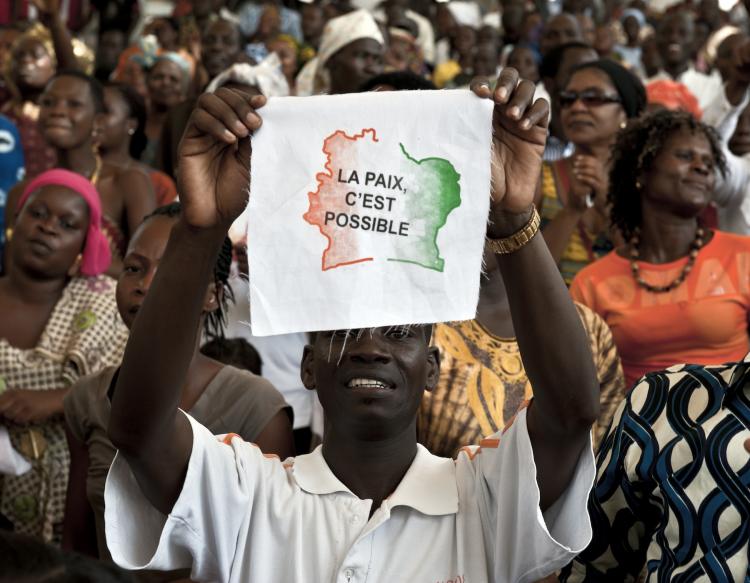 An Ivorian man displays a message on a piece of fabric reading in French 'Peace is possible' as 5.000 Ivorians gather on March 27, 2011 at the Culture Palace of Abidjan to pray for victory and peace. The four months' post electoral crisis was put to an end on April 11 with the arrest of the former President Laurent Gbagbo. (Jean-Philippe Ksiazek/Getty Images ) An Ivorian man displays a message on a piece of fabric reading in French 'Peace is possible' as 5.000 Ivorians gather on March 27, 2011 at the Culture Palace of Abidjan to pray for victory and peace. The four months' post electoral crisis was put to an end on April 11 with the arrest of the former President Laurent Gbagbo. (Jean-Philippe Ksiazek/Getty Images )