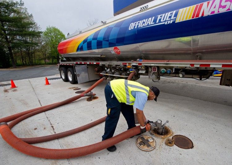 A tanker truck driver unloads various grades of gasoline into the underground tanks at a Sunoco gas station in April in Arlington, Virginia.  (Paul J. Richards/AFP/Getty Images)
