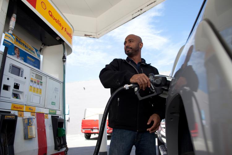 LOWER PRICES COMING: Samuel Lamb of San Jose, Calif. fills his truck with gasoline at a Shell gas station on April 27 in San Francisco. Gas prices nationally are expected to come down over the next few weeks as crude oil prices have plummeted. ( David Paul Morris/Getty Images )