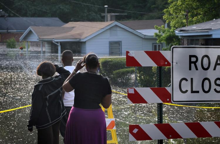Residents look at houses being engulfed by floodwater in the West Junction neighborhood May 8 in Memphis. (Scott Olson/Getty Images) Residents look at houses being engulfed by floodwater in the West Junction neighborhood May 8 in Memphis. (Scott Olson/Getty Images)