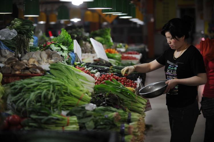 People shop for vegetables in a market in Beijing on May 11, 2011. The communist officials have their own safe food supply. (Peter Parks/AFP/Getty Images) People shop for vegetables in a market in Beijing on May 11, 2011. The communist officials have their own safe food supply. (Peter Parks/AFP/Getty Images)