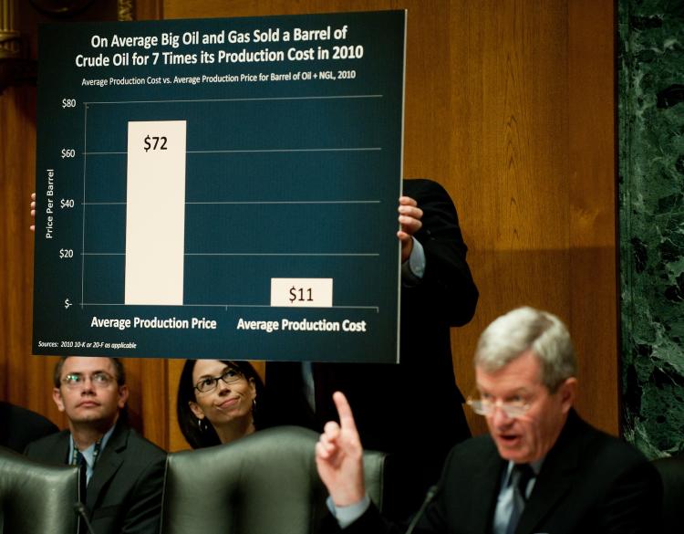 OIL PRICES: Chairman Max Baucus points to a graph showing the production price vs. the production cost for oil at a full Senate Finance Committee hearing on 'Oil and Gas Tax Incentives and Rising Energy Prices' on Capitol Hill in Washington, May 12. (Jim Watson/Getty Images )