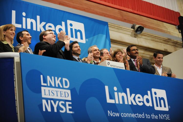 IPO SOARED: Linkedin founder Reid Garrett Hoffman (Center with beard) and CEO Jeff Weiner (2nd R) at the ringing of the opening bell of the New York Stock Exchange May 19 during the initial public offering of the company. (Stan Honda/AFP/Getty Images)