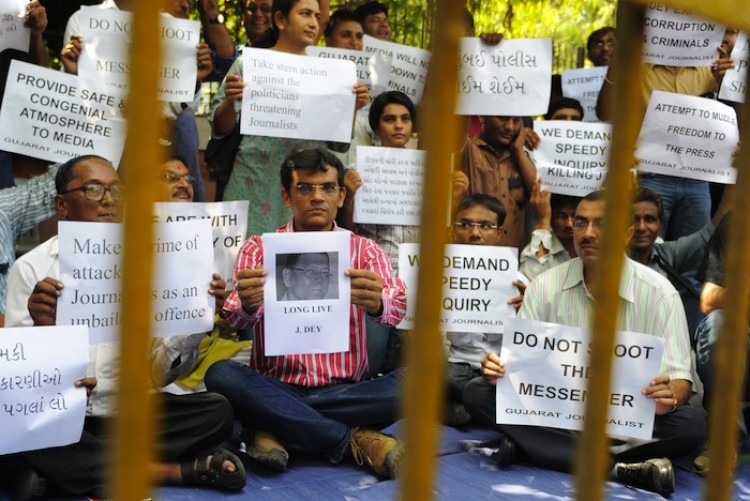 Gujarat based journalists from the print and electronic media fraternity stage a silent protest in memory of slain Mumbai based reporter, Jyotirmov Dey outside the Gandhi Ashram in Ahmedabad on June 14, (Sam Panthaky/AFP/Getty Images) Gujarat based journalists from the print and electronic media fraternity stage a silent protest in memory of slain Mumbai based reporter, Jyotirmov Dey outside the Gandhi Ashram in Ahmedabad on June 14, (Sam Panthaky/AFP/Getty Images)