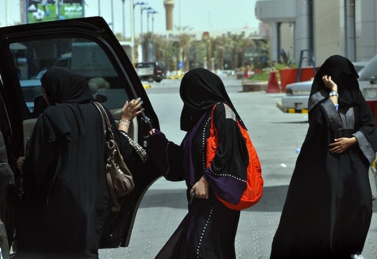 BEHIND THE WHEEL: Saudi women get into the backseat of a car in Riyadh on June 14, three days before a nationwide campaign by Saudi women to take the wheel in protest against a driving ban which is unique to the kingdom.  (Fayez Nureldine/AFP/Getty Images)