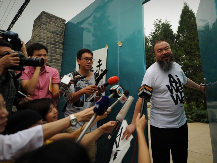 Outspoken Chinese artist Ai Weiwei arrives to speak to reporters outside his studio in Beijing on June 23. Weiwei has accepted a job to teach at the University of Berlin, but it's unclear whether he'll be allowed out of China. (Peter Parks/Getty Images) Outspoken Chinese artist Ai Weiwei arrives to speak to reporters outside his studio in Beijing on June 23. Weiwei has accepted a job to teach at the University of Berlin, but it's unclear whether he'll be allowed out of China. (Peter Parks/Getty Images)
