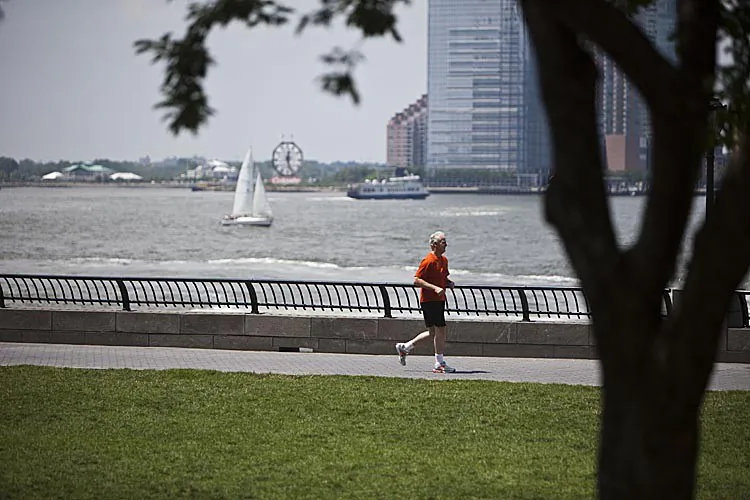 A man runs along the Hudson River in Battery Park City in Lower Manhattan, New York City, on July 12, 2011. (Ramin Talaie/Getty Images)