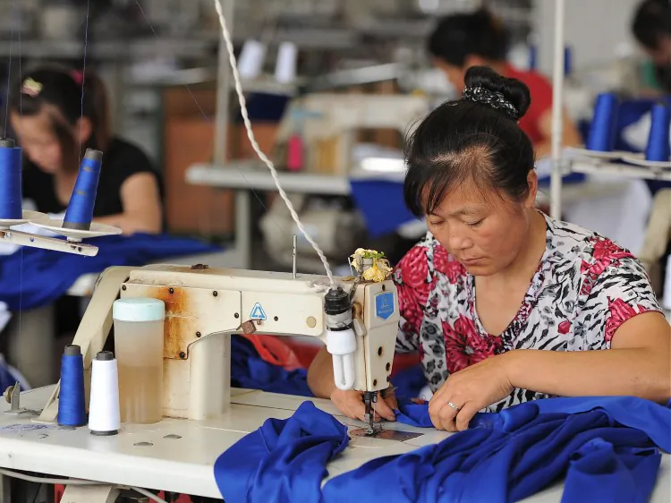 Laborers working at a clothes factory in Hefei, in east China's Anhui Province. China’s garment manufacturing industry is experiencing a downturn. (STR/AFP/Getty Images)