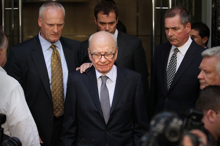 News Corp. Chairman Rupert Murdoch leaves the One Aldwych Hotel surrounded by his personal security team to speak with reporters after meeting with the family of murdered school girl Milly Dowler on July 15, in London, England. (Peter Macdiarmid/Getty Images) News Corp. Chairman Rupert Murdoch leaves the One Aldwych Hotel surrounded by his personal security team to speak with reporters after meeting with the family of murdered school girl Milly Dowler on July 15, in London, England. (Peter Macdiarmid/Getty Images)