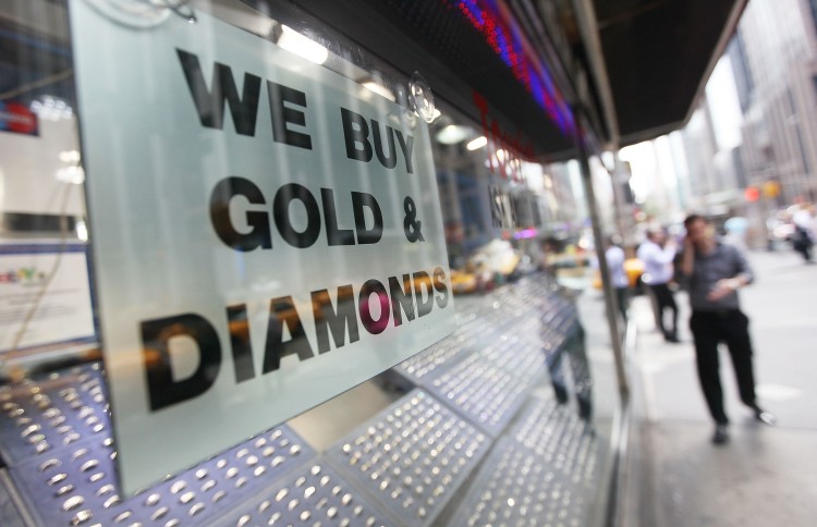 NEW RECORD: A 'We Buy Gold & Diamonds' sign is seen in Manhattan's Diamond District, July 18. The price of gold rose above $1600 an ounce Monday, setting a new all-time record.  (Mario Tama/Getty Images)