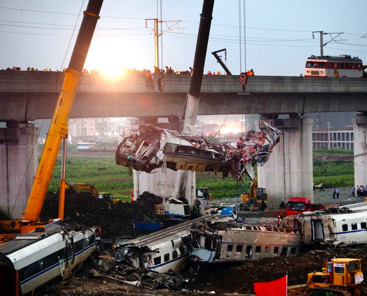 A mangled train car is hoisted away after the deadly Wenzhou collision of two trains on July 24, in China. (ChinaFotoPress/Getty Images)