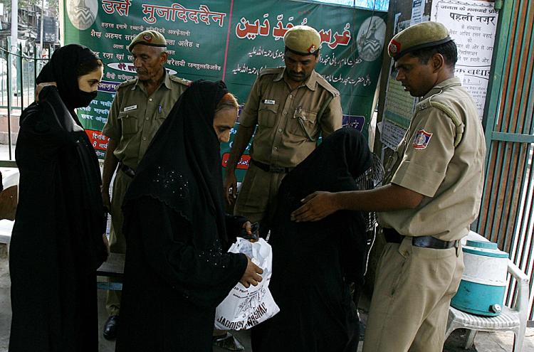 Indian police check the bags of Indian Muslim women visiting the Jama Masjid mosque (Background) in New Delhi on July 27, 2008, after security was put on high alert across the country following the bomb blasts in Ahmedabad. (Manpreet Romana/AFP/Getty Images) Indian police check the bags of Indian Muslim women visiting the Jama Masjid mosque (Background) in New Delhi on July 27, 2008, after security was put on high alert across the country following the bomb blasts in Ahmedabad. (Manpreet Romana/AFP/Getty Images)