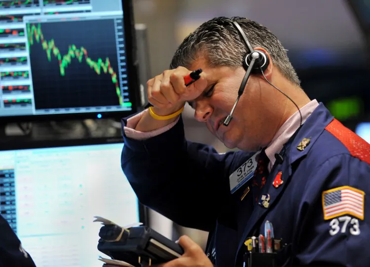 A trader works on the floor of the New York Stock Exchange on Aug. 4, 2011. (Stand Honda/Getty Images)