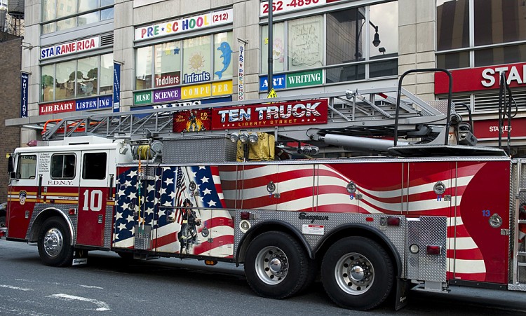 A NYFD city firetruck outside a Times Square fire station