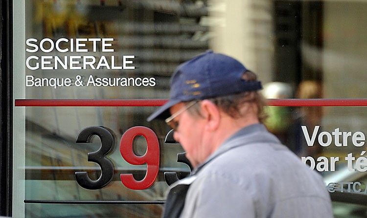 UNDER PRESSURE: A man passes by a French bank Societe Generale's agency, in Dunkerque, northern France, on Aug. 10. Societe Generale's shares plummeted last week amid a period of severe negative sentiment on the stocks of European banks, prompting several European regulators to ban short selling. (PHILIPPE HUGUEN/AFP/Getty Images)