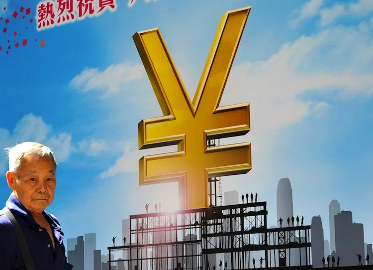 An elderly man walks past a poster advertising the Chinese yuan (renminbi currency) in Hong Kong on Aug. 18, 2011. (Laurent Fievet/AFP/Getty Images)