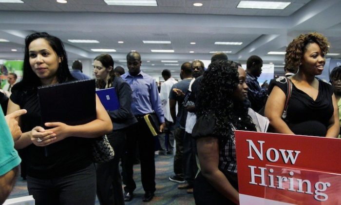 People looking for work at a recruiter's desk setup at a job fair in the James L. Knight Center, in Miami, Fla. (Joe Raedle/Getty Images)