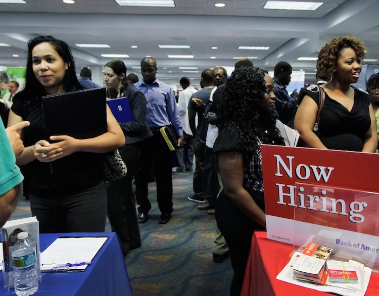 People looking for work at a recruiter's desk setup at a job fair in the James L. Knight Center, in Miami, Fla. (Joe Raedle/Getty Images)
