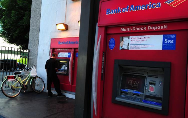 A man uses an automated teller machine ( Epoch Times Photo
