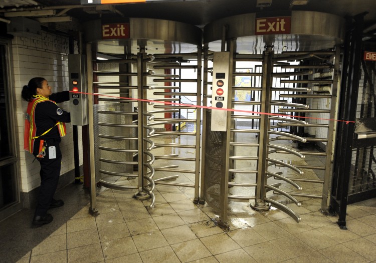 A MTA worker lockes up a gate at Union Square station A MTA worker lockes up a gate at Union Square station