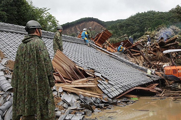 Rescue workers and Japan Self-Defense Force soldiers search for missing people amongst a destroyed house caused by flood waters in Tanabe, Wakayama prefecture, in western Japan. (JIJI PRESS/AFP/Getty Images) Rescue workers and Japan Self-Defense Force soldiers search for missing people amongst a destroyed house caused by flood waters in Tanabe, Wakayama prefecture, in western Japan. (JIJI PRESS/AFP/Getty Images)