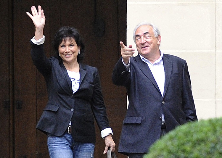 Former International Monetary Fund (IMF) leader Dominique Strauss-Kahn (R) and his wife Anne Sinclair wave from the courtyard upon their arrival in their Paris home in Place des Vosges, on September 4, after flying from New York. (MIGUEL MEDINA/AFP/Getty Images) Former International Monetary Fund (IMF) leader Dominique Strauss-Kahn (R) and his wife Anne Sinclair wave from the courtyard upon their arrival in their Paris home in Place des Vosges, on September 4, after flying from New York. (MIGUEL MEDINA/AFP/Getty Images)