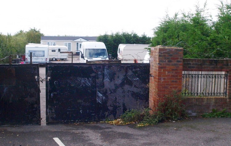 A sealed gate to the the Green Acres caravan site is pictured in Leighton Buzzard, north of London, on September 12, 2011. British police raided a travellers' site Sunday to rescue 24 men they said had been held as slaves and forced to live in squalor, some for up to 15 years. More than 200 officers from Bedfordshire Police entered the Green Acres caravan site and arrested four men and one woman, all residents on the site, on suspicion of slavery offences. (Max Nash/AFP/Getty Images) A sealed gate to the the Green Acres caravan site is pictured in Leighton Buzzard, north of London, on September 12, 2011. British police raided a travellers' site Sunday to rescue 24 men they said had been held as slaves and forced to live in squalor, some for up to 15 years. More than 200 officers from Bedfordshire Police entered the Green Acres caravan site and arrested four men and one woman, all residents on the site, on suspicion of slavery offences. (Max Nash/AFP/Getty Images)