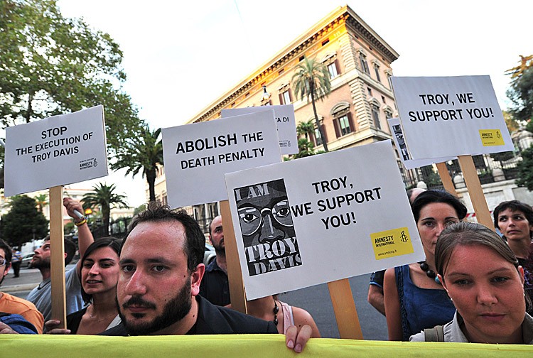 Amnesty International activists hold banners in support of Troy Davis in front of the US Embassy in Rome on September 16, during a protest to denounce the death penalty in the United States. Davis was sentenced to death in 1991. (ALBERTO PIZZOLI/AFP/Getty Images) Amnesty International activists hold banners in support of Troy Davis in front of the US Embassy in Rome on September 16, during a protest to denounce the death penalty in the United States. Davis was sentenced to death in 1991. (ALBERTO PIZZOLI/AFP/Getty Images)