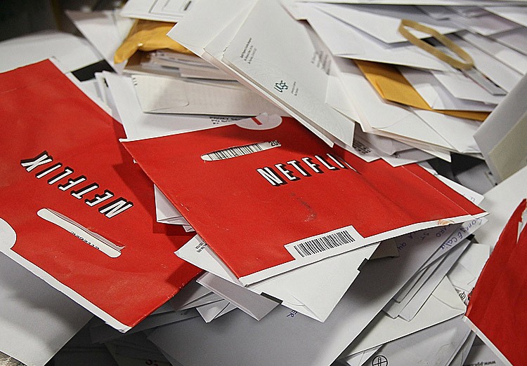 Red Netflix envelopes sit in a bin of mail at the U.S. Post Office sort center March 30, 2010 in San Francisco, Calif. Netflix announced Sept. 19, 2011 that they would spin off their DVD-by-mail service into a separate named company called Qwikster, keeping the Netflix name for their streaming service. (Justin Sullivan/Getty Images)