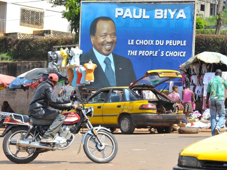 A biker rides past street vendors selling their goods under a huge poster of Cameroon's incumbent president and presidential candidate Paul Biya in a street of Yaounde on Oct. 5. Last week the Supreme Court of Cameroon announced that the incumbent President Paul Biya had won 77.98 percent of the votes, in a battle against 22 opponents. For the first time in this year's elections the diaspora was also allowed to vote. (Seyllou/AFP/Getty Images) A biker rides past street vendors selling their goods under a huge poster of Cameroon's incumbent president and presidential candidate Paul Biya in a street of Yaounde on Oct. 5. Last week the Supreme Court of Cameroon announced that the incumbent President Paul Biya had won 77.98 percent of the votes, in a battle against 22 opponents. For the first time in this year's elections the diaspora was also allowed to vote. (Seyllou/AFP/Getty Images)