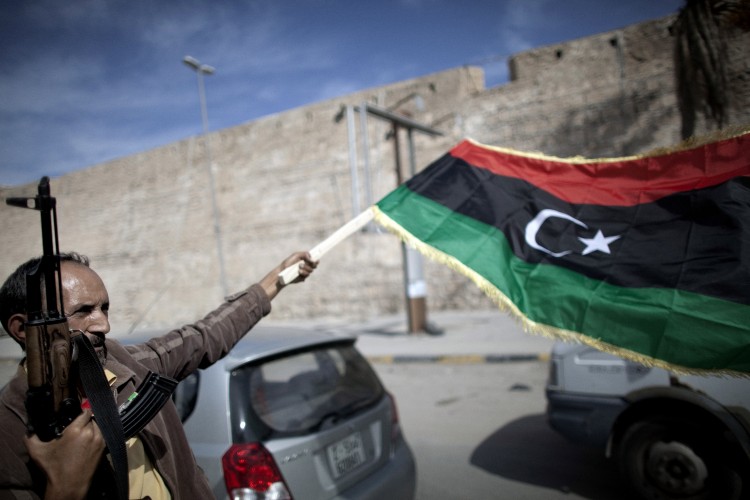 A Libyan fighter waves a National Transitional Council (NTC) flag as he celebrates in the streets of Tripoli following news of Muammar Gaddafi's capture on Oct. 20. (MARCO LONGARI/AFP/Getty Images) A Libyan fighter waves a National Transitional Council (NTC) flag as he celebrates in the streets of Tripoli following news of Muammar Gaddafi's capture on Oct. 20. (MARCO LONGARI/AFP/Getty Images)