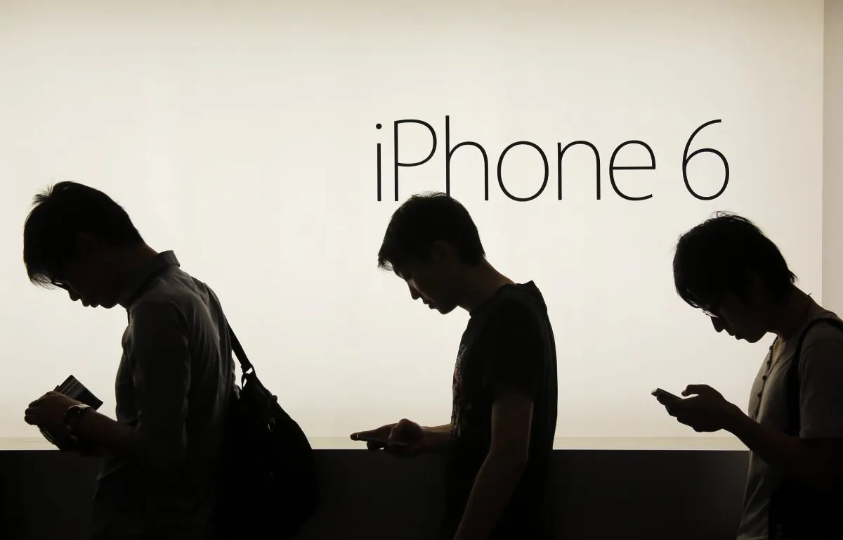 People wait to buy the new Apple iPhone 6 and 6 Plus devices outside an Apple store in Hong Kong on Sept. 19, 2014. (AP Photo/Vincent Yu)
