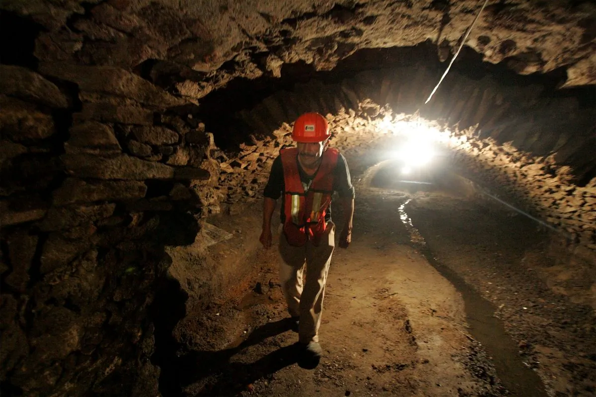 A worker walks through one of the recently discovered ancient tunnels underneath the city of Puebla, Mexico, Thursday, Sept. 3, 2015. (AP Photo/Joel Merino)