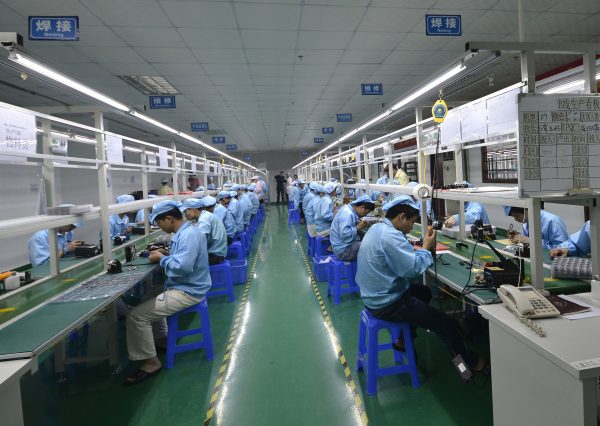 Chinese workers assemble a cheaper local alternative to the Apple Watch in a factory in Shenzhen on April 22. (STR/AFP/Getty Images)