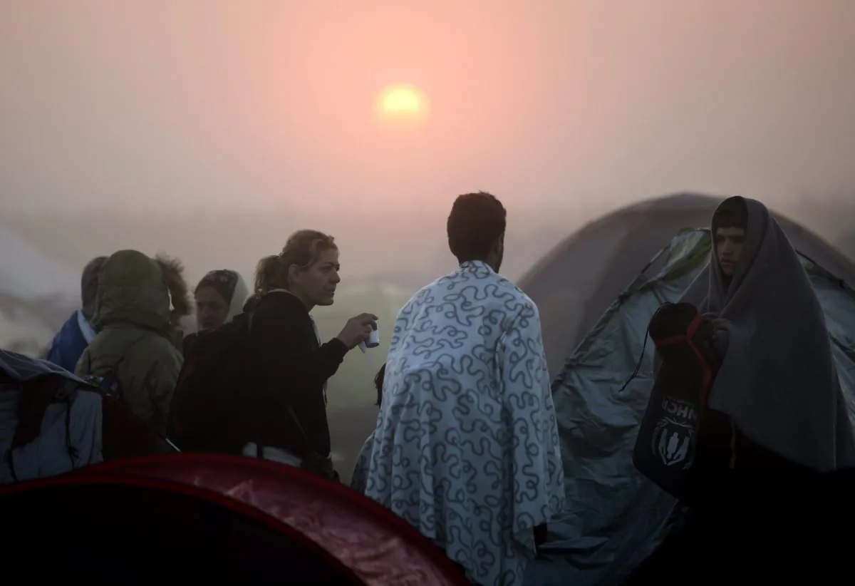 Illegal immigrants gather in their camp in Roszke, Hungary, at the border between Hungary and Serbia, on Sept. 13, 2015. (Balazs Mohai/MTI via AP)