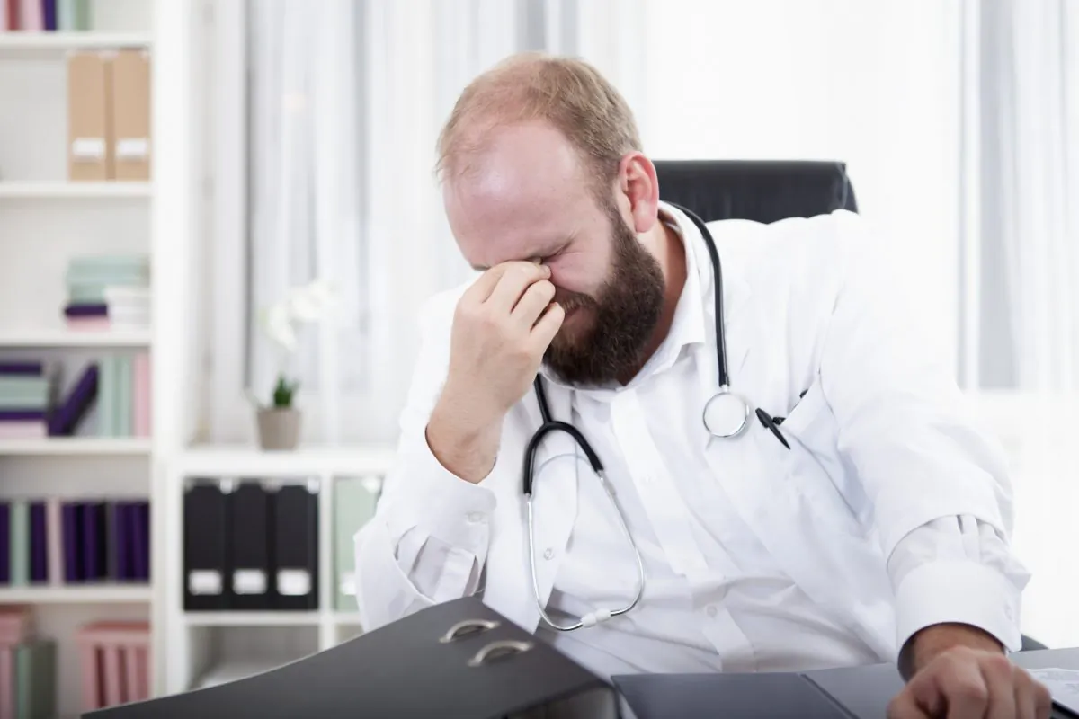 A general practitioner, an ordinary superhero, but under pressure of burnout, depression, and even suicide. (Tuned_In/iStock)