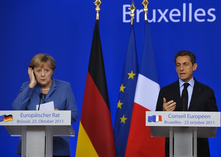 German Chancellor Angela Merkel (L) listens to French President Nicolas Sarkozy during a joint press conference as part of the European Council at EU headquarters in Brussels on Oct. 23. (ERIC FEFERBERG/AFP/Getty Images) German Chancellor Angela Merkel (L) listens to French President Nicolas Sarkozy during a joint press conference as part of the European Council at EU headquarters in Brussels on Oct. 23. (ERIC FEFERBERG/AFP/Getty Images)