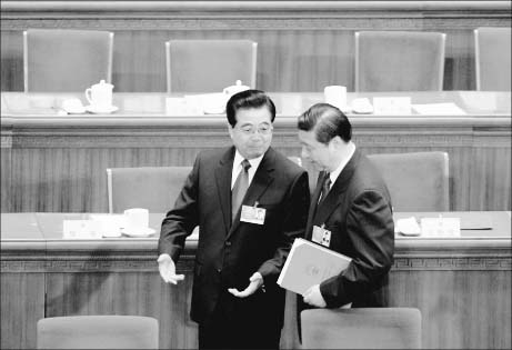New Party head Xi Jinping (R) and outgoing leader Hu Jintao engage in a conversation. After the 18th Congress last year, the Hu-Xi team has appointed its trusted men to key positions in the Party's Central Committee, the Central Military Commission, the State Council, and provincial committees, leaving previous Party head Jiang Zemin's camp only a small majority in the Politburo Standing Committee. (Getty Images)  