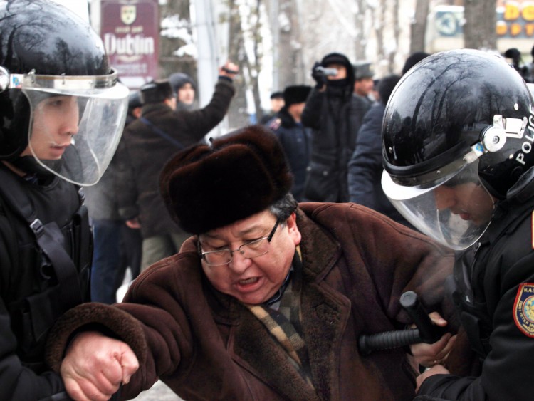 Kazakh riot policemen detain an opposition supporter during a rally in Almaty on December 17, 2011. (Anatoly Ustinenko/AFP/Getty Images)