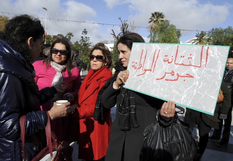 Tunisian artists hold a sign Epoch Times Photo