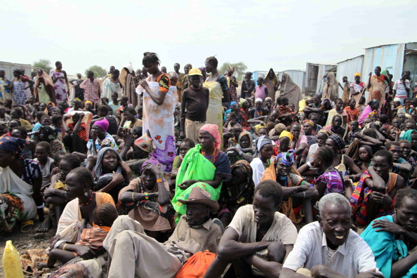 People wait for food distribution in Pib Epoch Times Photo