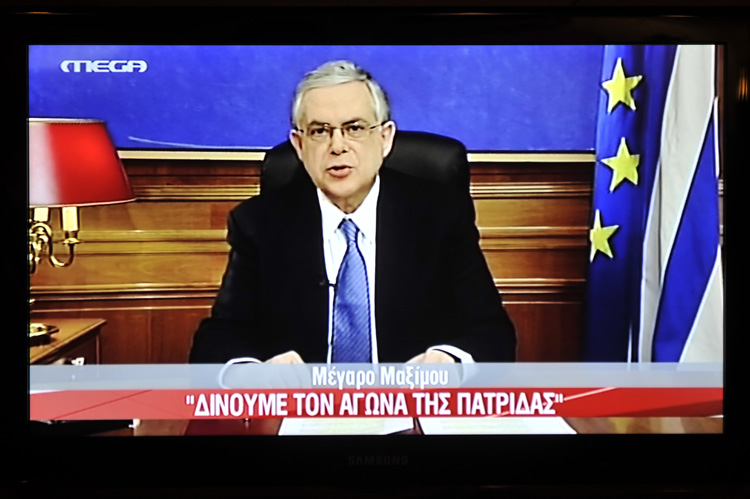 A picture of a TV screen shows Greek Prime Minister Lucas Papademos A picture of a TV screen shows Greek Prime Minister Lucas Papademos