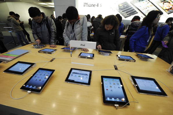 Customers look at Apple iPads at a store