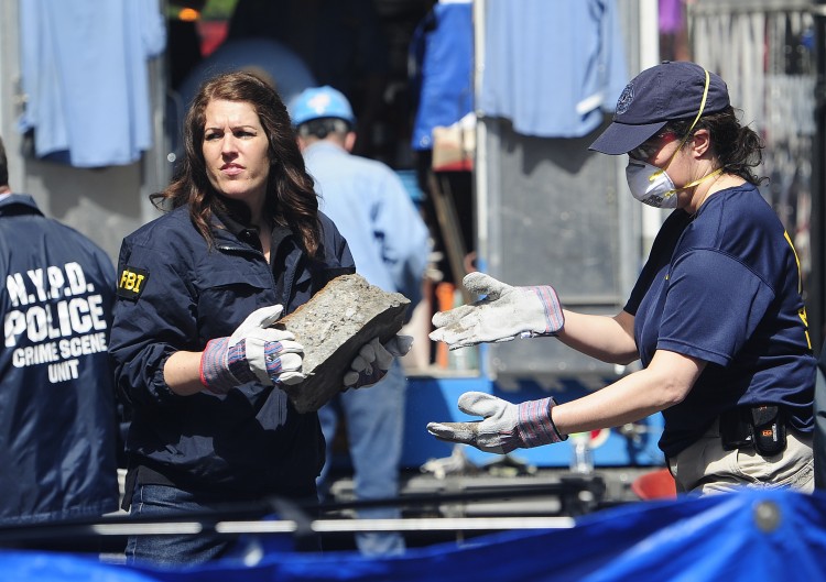 New York police and FBI agents remove pieces of concrete New York police and FBI agents remove pieces of concrete