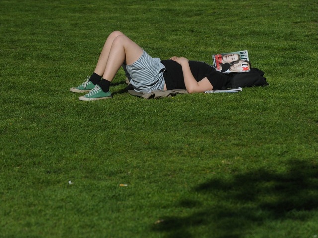 143477897 A man sleeps in the grass in April, 2012 in Prague.