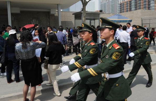 Chinese military policemen march to chan Epoch Times Photo