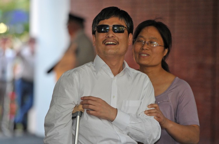 Chinese activist Chen Guangcheng Chinese activist Chen Guangcheng (C) and his wife Yuan Weijing (R) arrive at the New York University Village apartment complex in Manhattan in New York, May 19 Mladen Antonov/AFP/GettyImages)