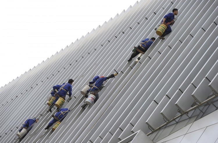 Workers clean the facade of a building i Workers clean the facade of a building i