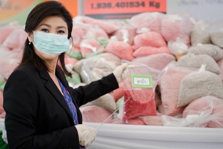 Thailand's Prime Minister Yingluck Shinawatra stands in front of bags of methamphetamine tablets in June 29, 2012. (Nicolas Asfouri/AFP/GettyImages)